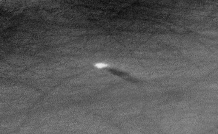 Bright disc above large Martian crater