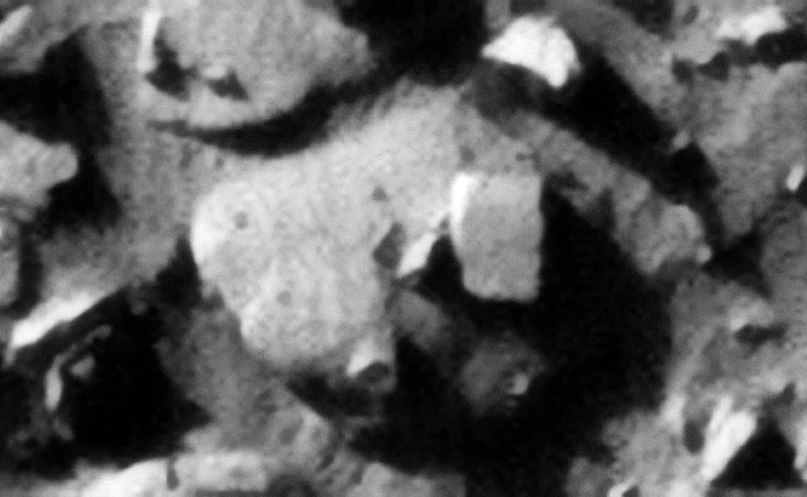 An excellent example of a knob sticking out of a larger object; note the small hexagonal knob to the bottom left of the main object and how it joins to it. A rectangular megalithic block is seen lying on top of the main object