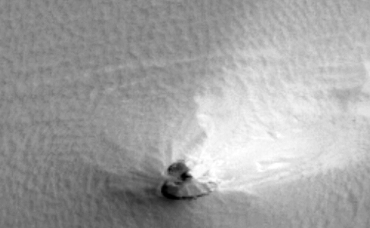 Triangular craft half buried in Martian soil