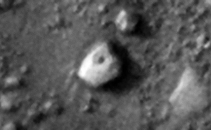 Strange multi-sided megalithic block or perhaps craft, note the dark spot in the center of the hexagon shaped top