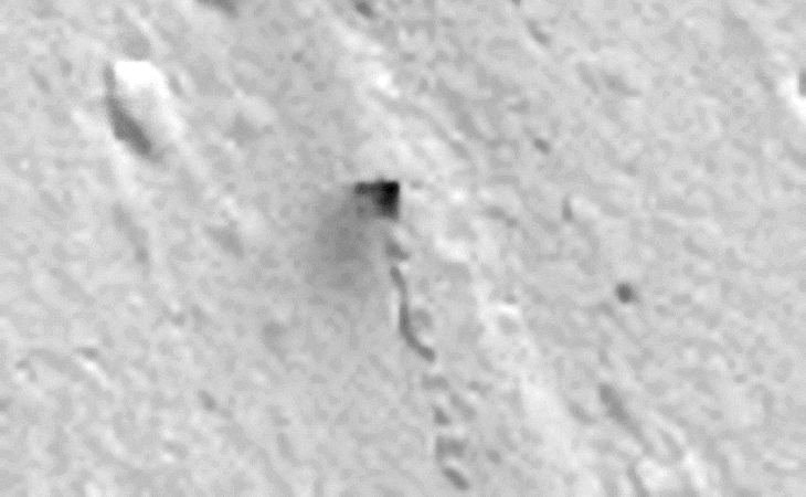 Boulder or Vehicle? The track starts and runs over a flat-plain, a boulder or rock cannot role naturally over a flat plain. The object also appears to be leaving a dark coloured stain on the Martian surface or is that smoke?