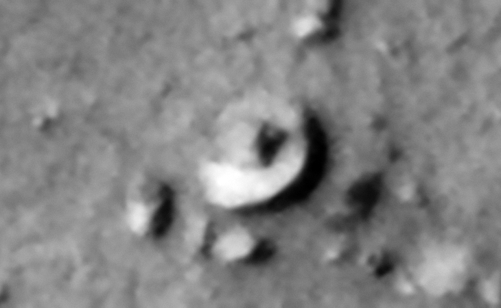 Saucer-shaped craft sitting on the Martian surface