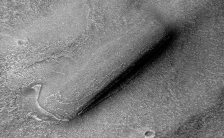 The '2001: A Space Odyssey Monolith' lying on the Martian surface covered in sand and dust
